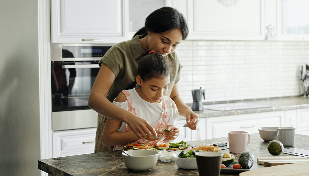 Healthy Vegan Kid and Mom Prepping a Meal.